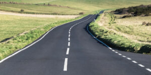 Road bending away around a hill, representing the future, and life after loss