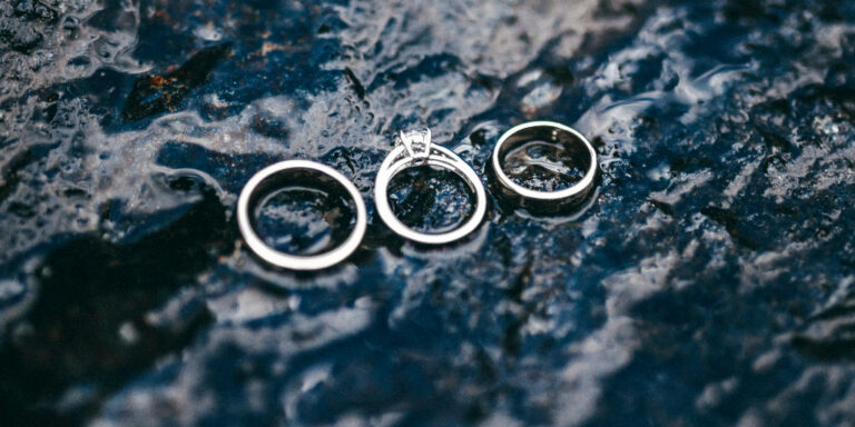 3 wedding rings on a dark surface, symbolizing the question "Can Christian Widows Remarry?"