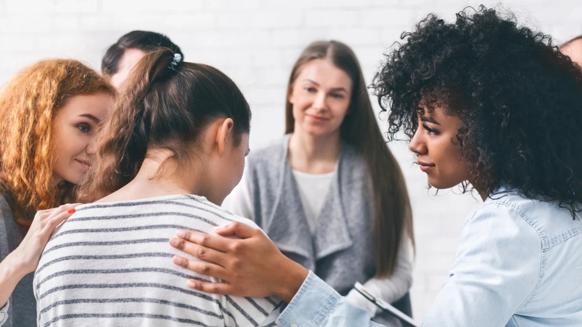 women comforting a grieving friend